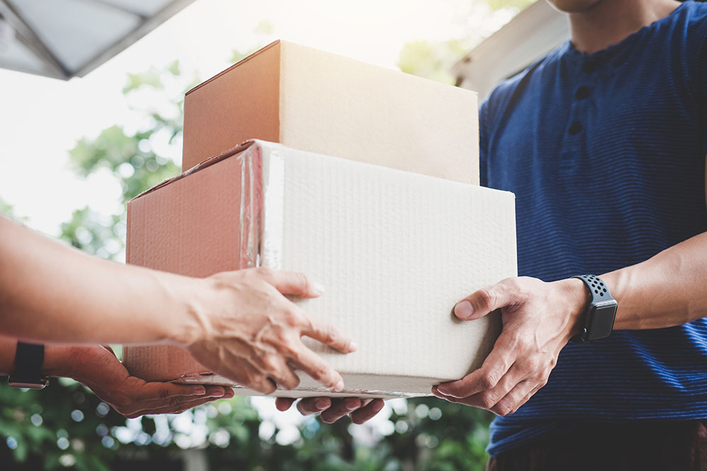 a person bringing a package to another person