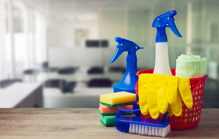 photo of a closeup of cleaning supplies and an office in the background